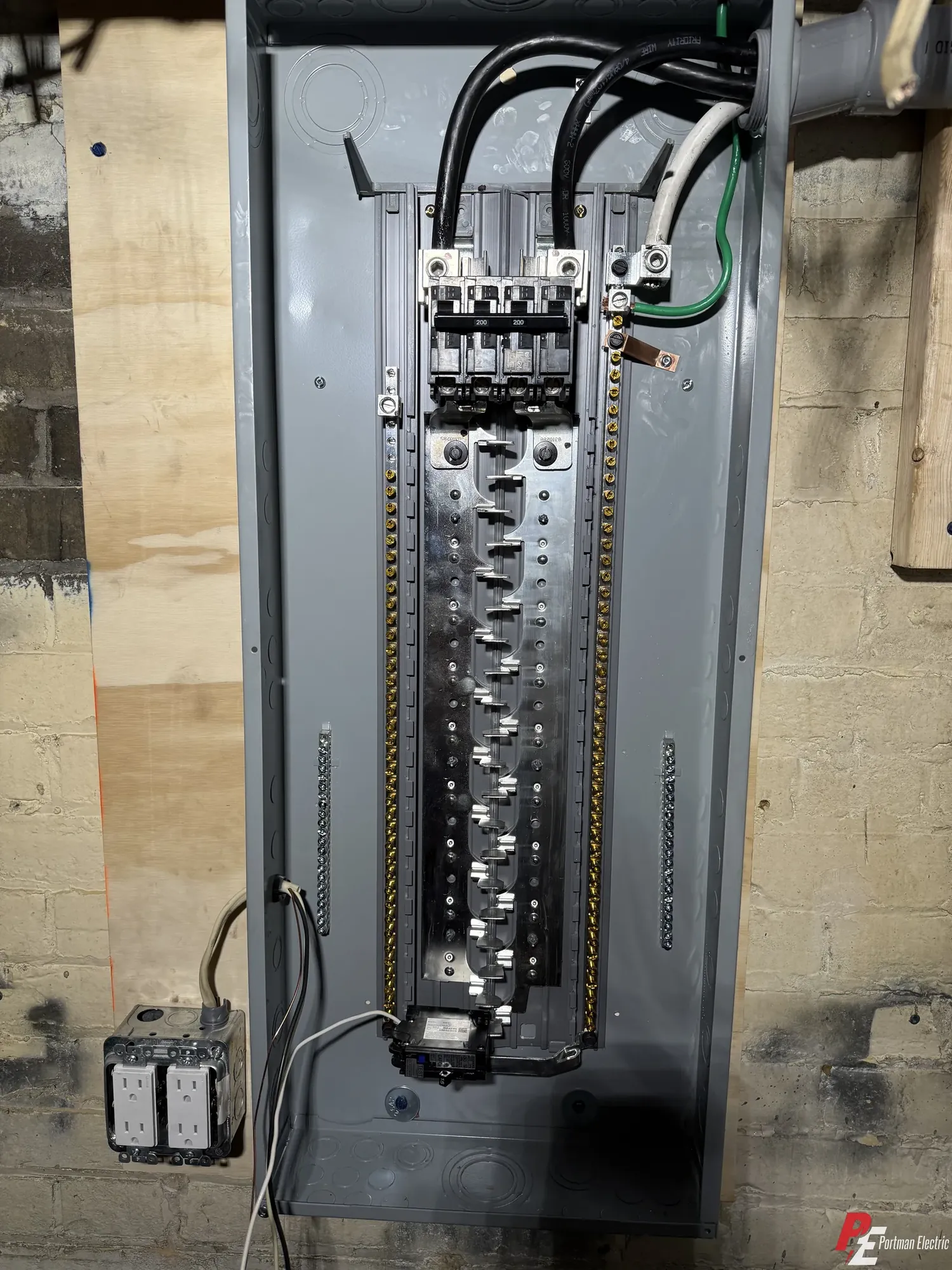 Interior of a new 200 amp electrical panel showing the main breaker and neatly dressed conductors