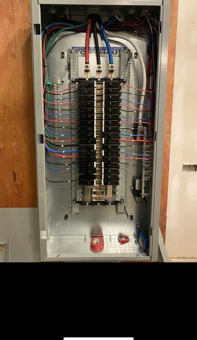 Interior of a finished breaker panel with neatly routed and terminated branch circuits