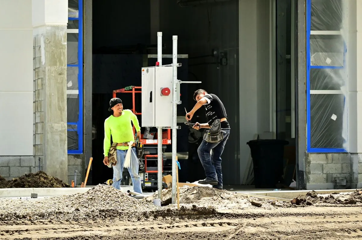 Electrical workers with equipment at a commercial construction site