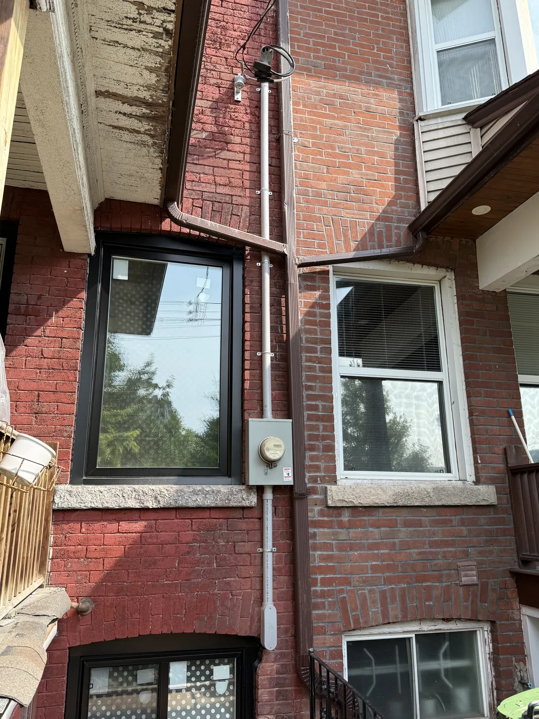 Exterior electrical service mast and meter equipment on a brick home