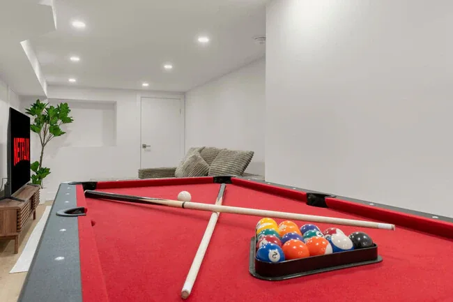 Pot lights installed in a finished basement living space by Portman Electric
