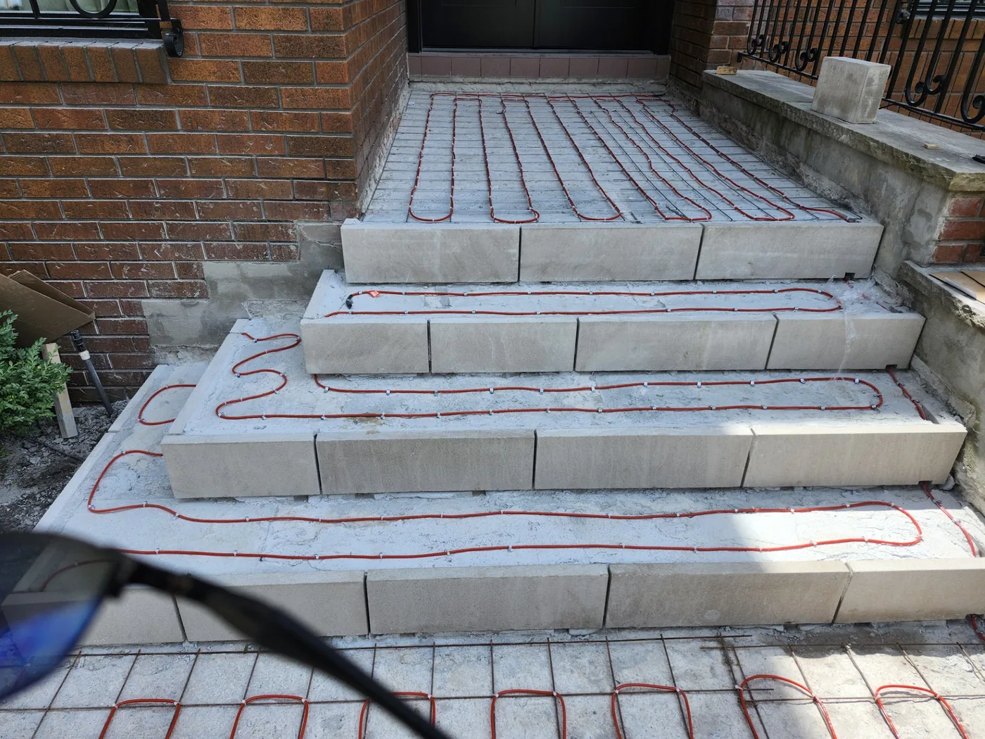 Snow-melting heating cable laid into exterior steps before the finished surface goes down