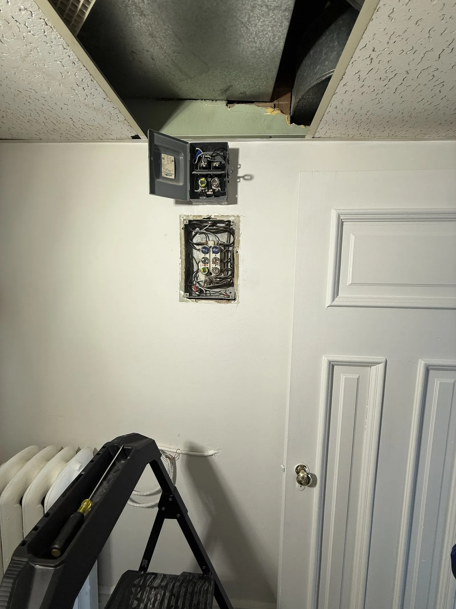 Older fuse panel in a Toronto home before replacement