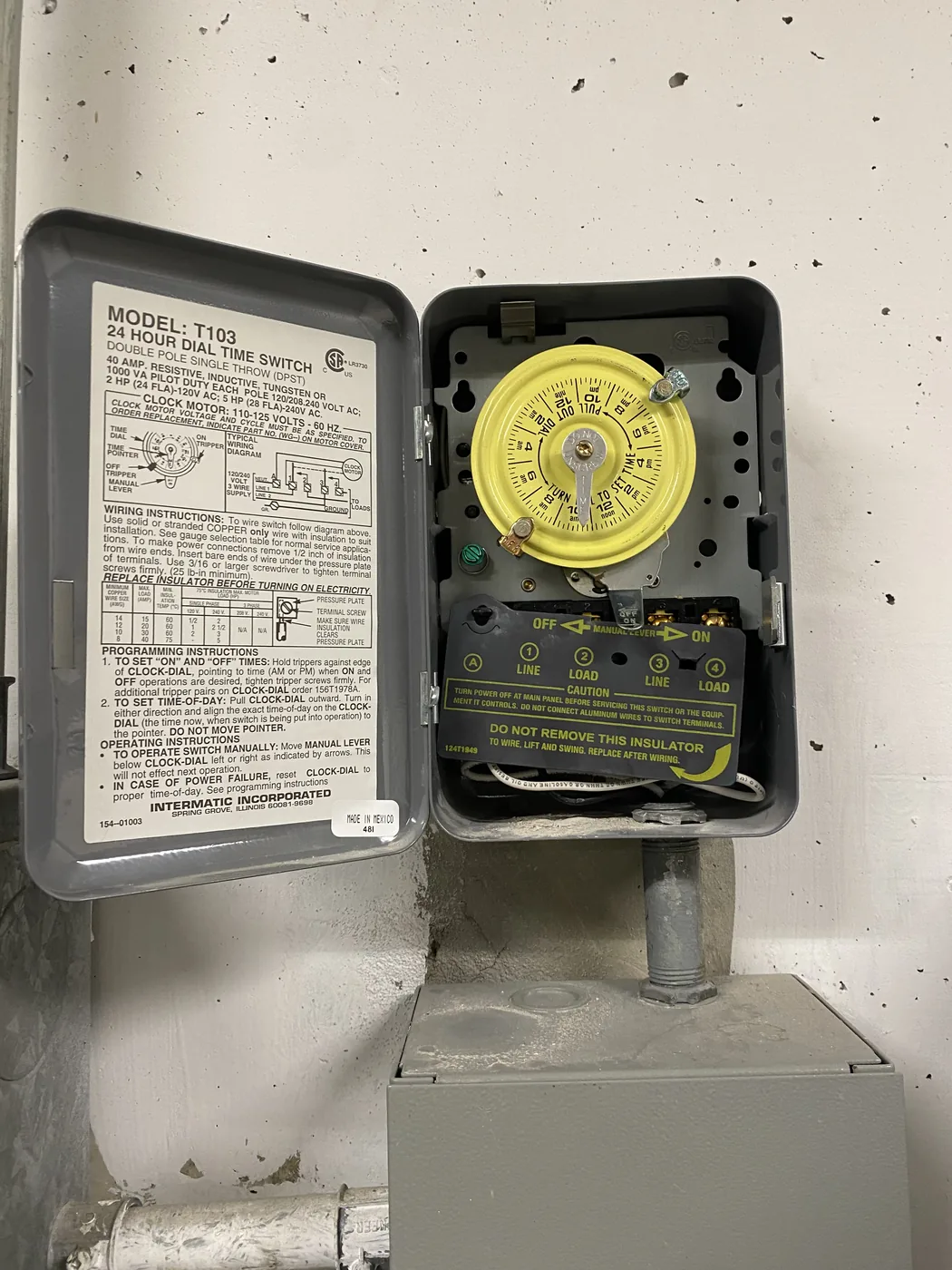 24-hour dial time switch controlling common-area lighting in a multi-residential building, open for service