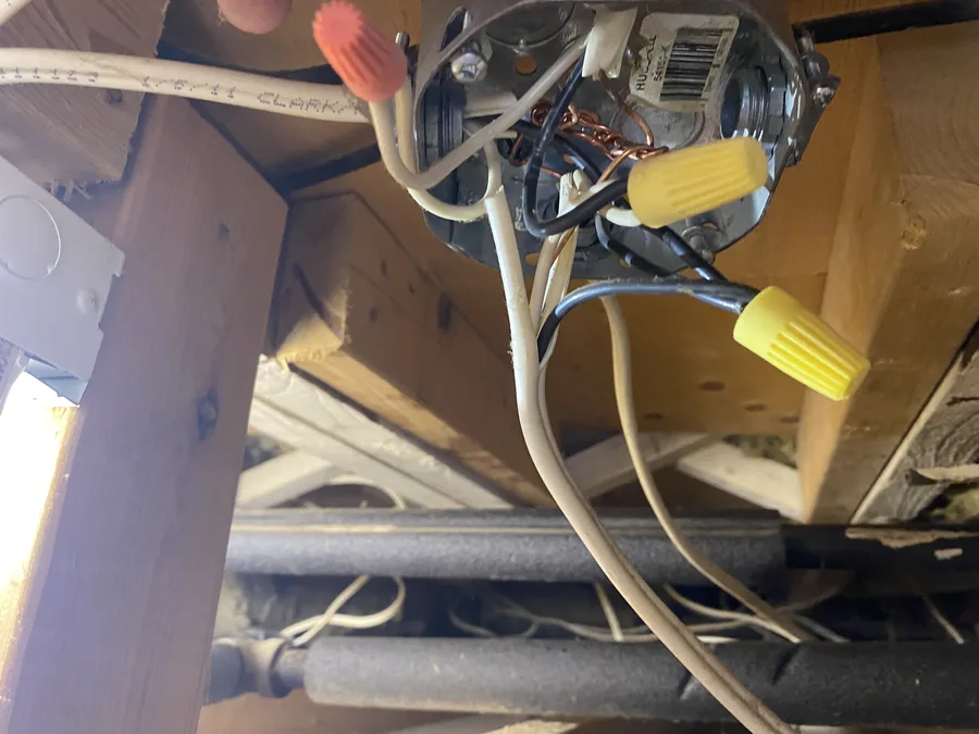Open junction box with exposed wiring documented during an electrical inspection