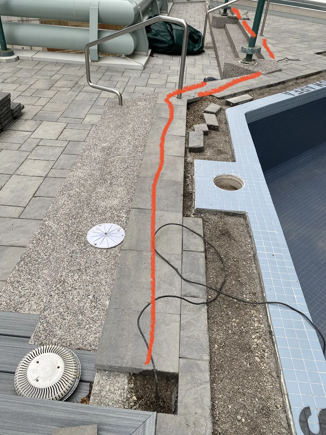 Electrical conduit and bonding runs at a backyard pool deck installed by Portman Electric