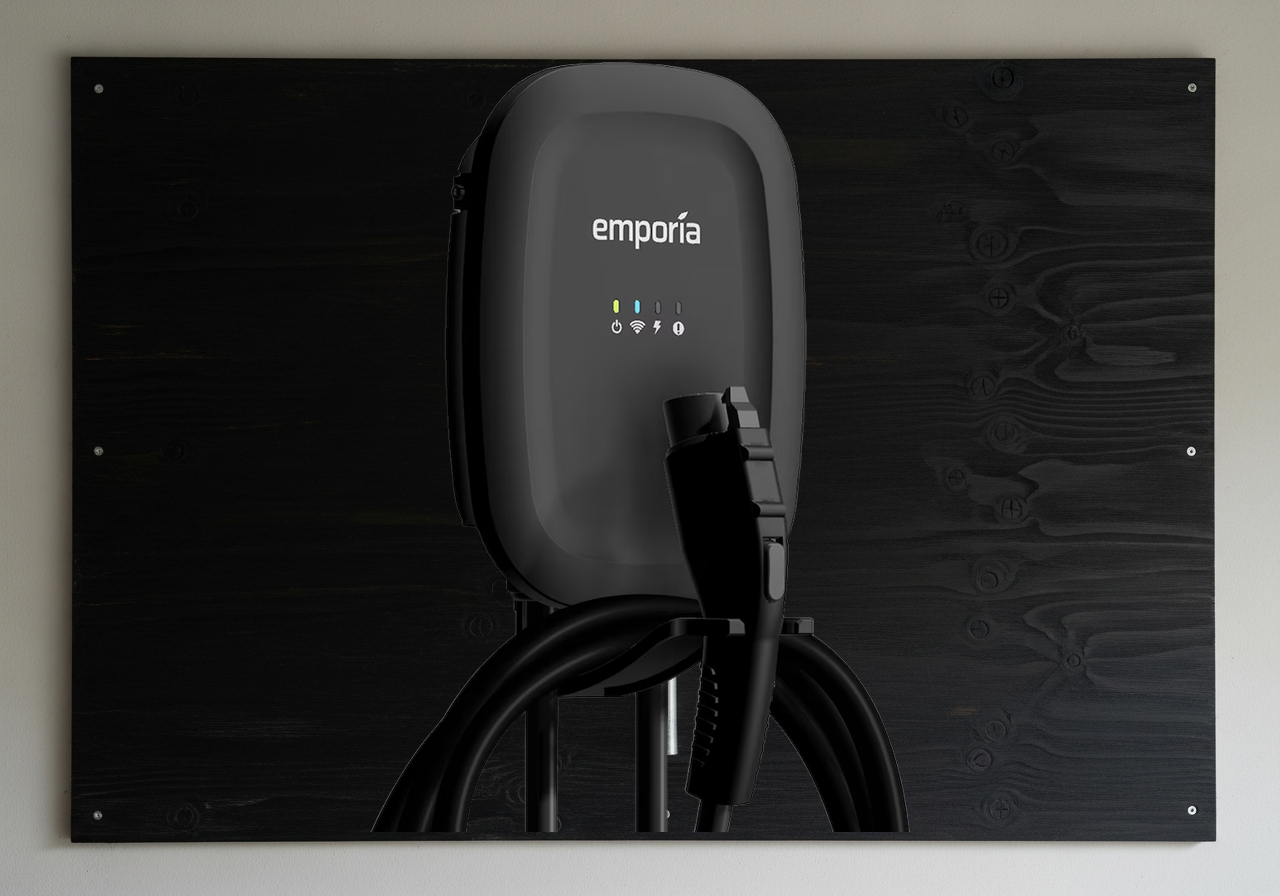 Emporia hardwired Level 2 EV charger on black plywood in a Toronto garage
