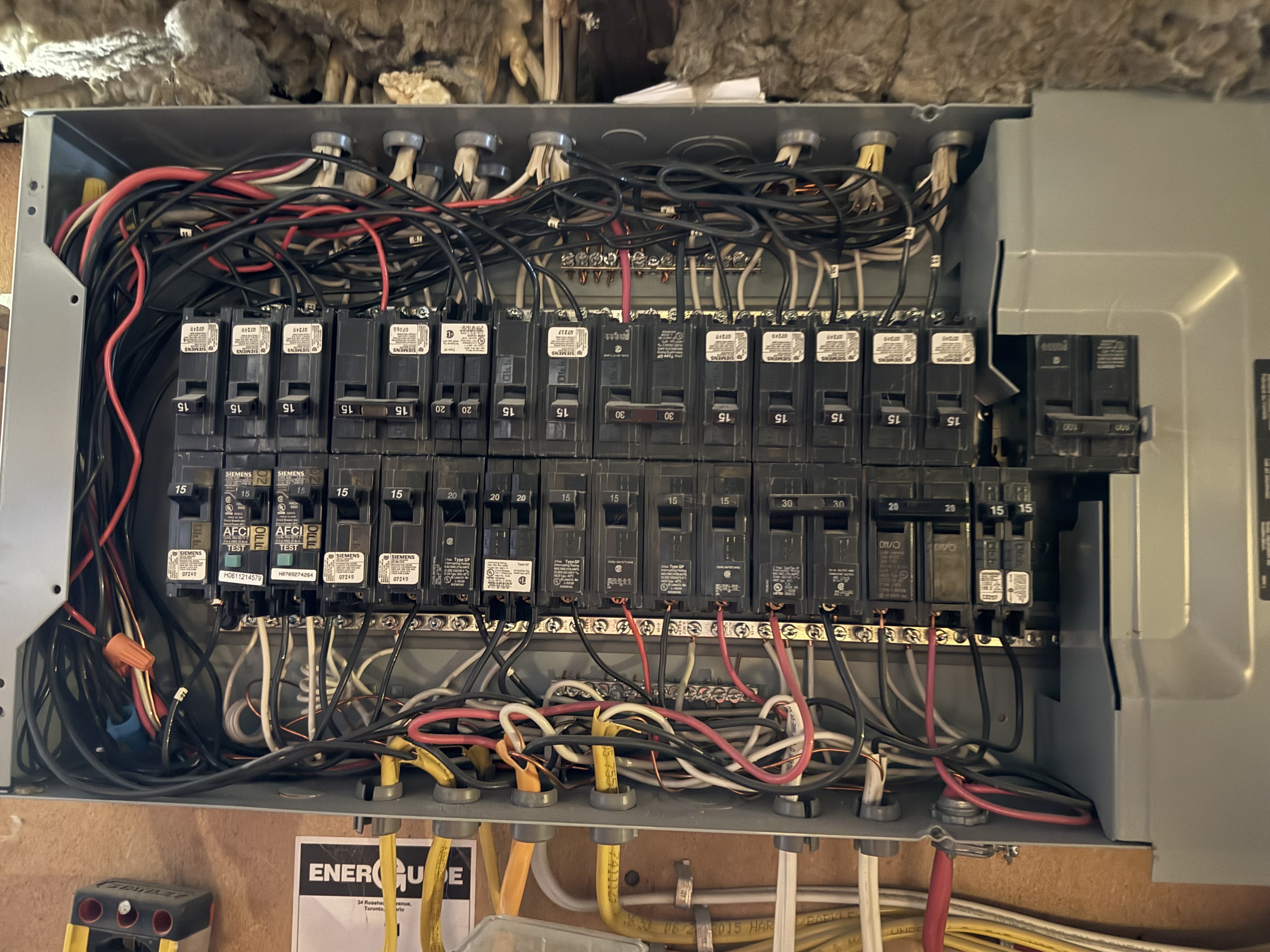 Older fully-loaded electrical panel with no spare breaker spaces — a candidate for a 200A panel upgrade before EV charging