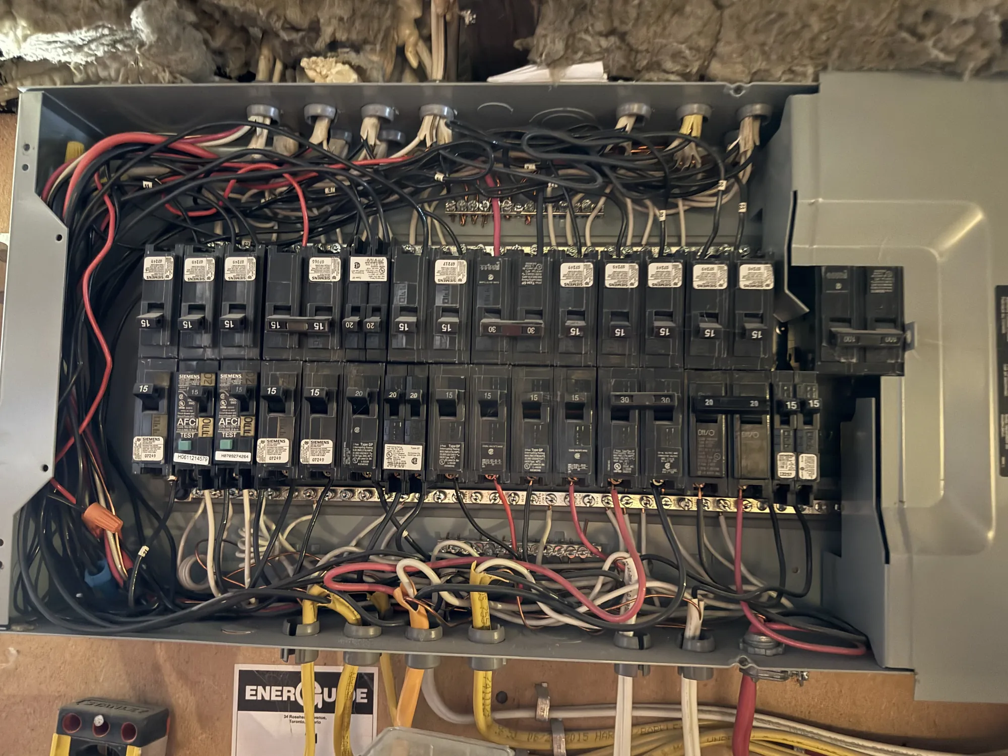 Older fully-loaded electrical panel with no spare breaker spaces — a candidate for a 200A panel upgrade before EV charging