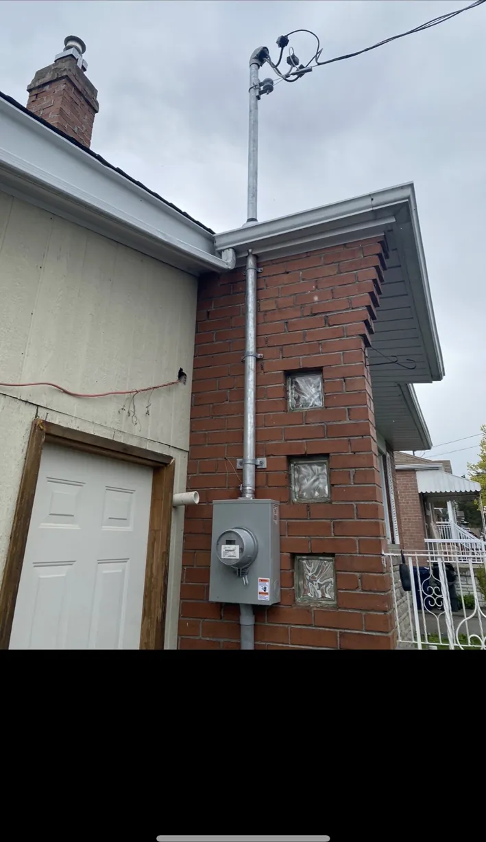 Exterior meter and service mast after a 200 amp electrical service upgrade in Toronto.