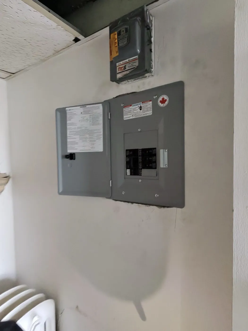 Completed breaker panel replacing old fuse equipment in a St. Clair West Toronto building.