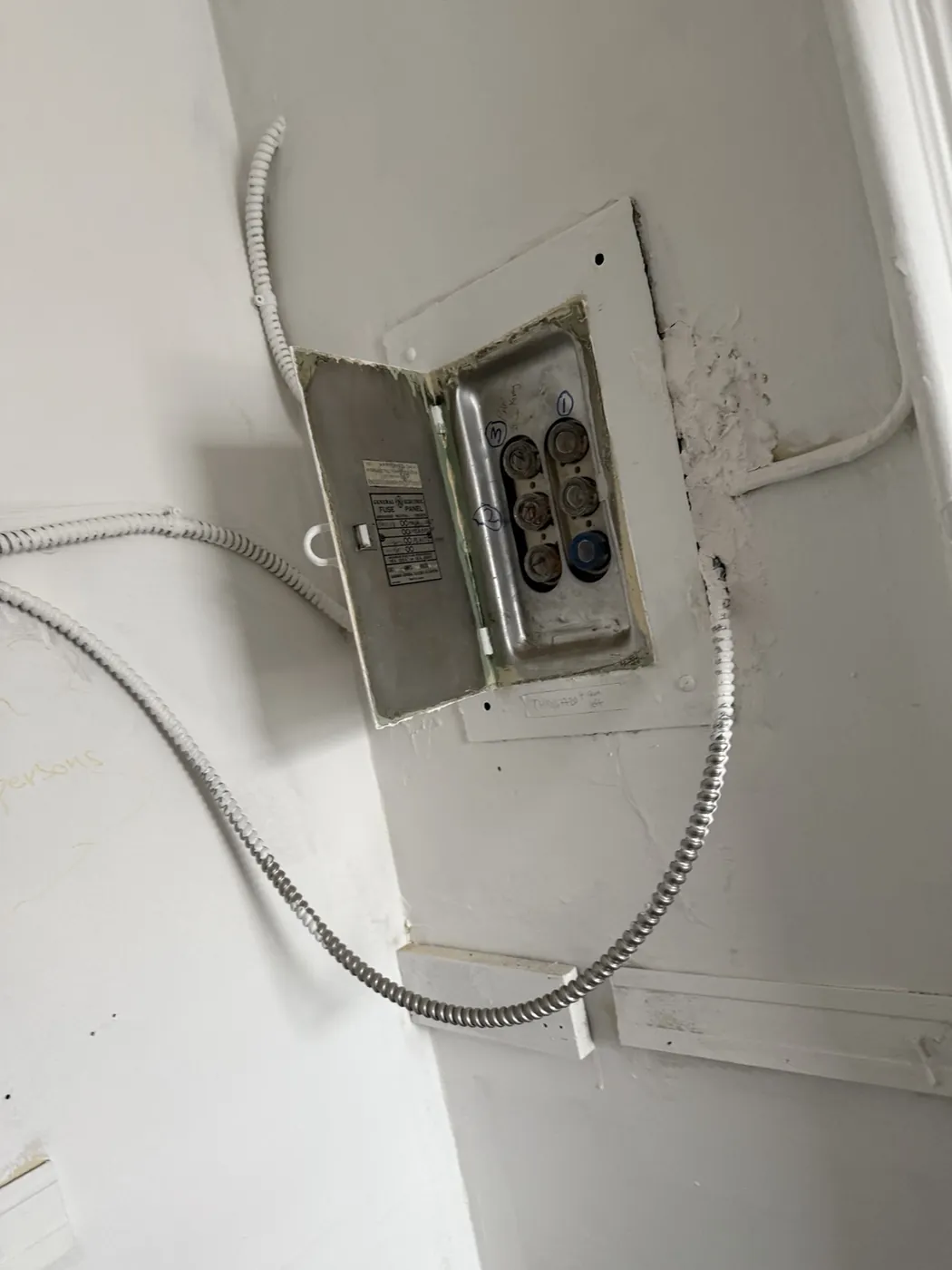 Original fuse box in a 100-year-old St. Clair West Toronto building before the electrical upgrade.
