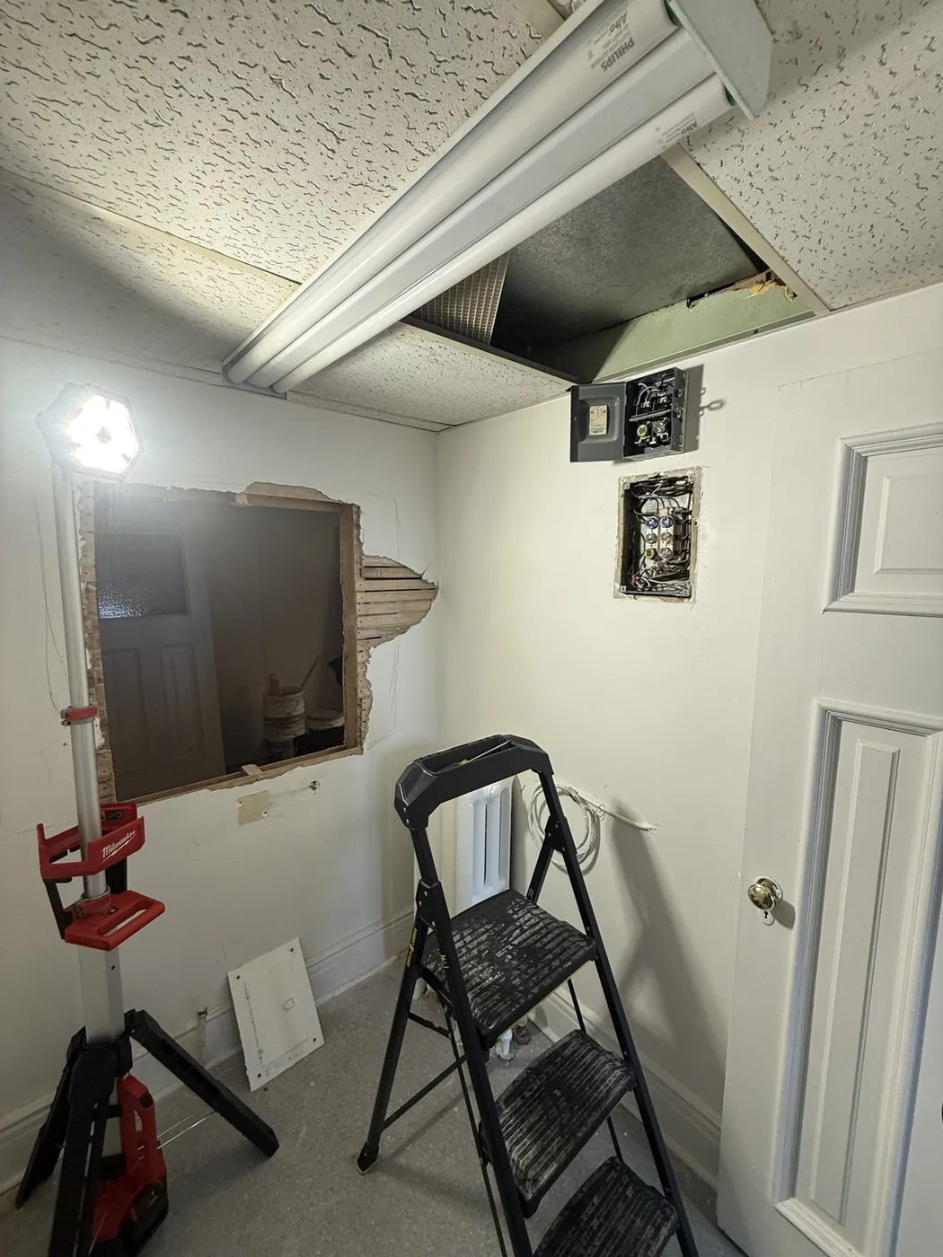 Commercial tenant space in Toronto during an electrical upgrade with the original distribution equipment opened.